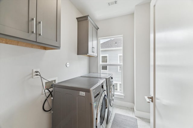 919 W 16th St Unit C, Houston, TX 77008 - laundry room with cabinet space, light marble finish flooring, washer and dryer, and plenty of natural light