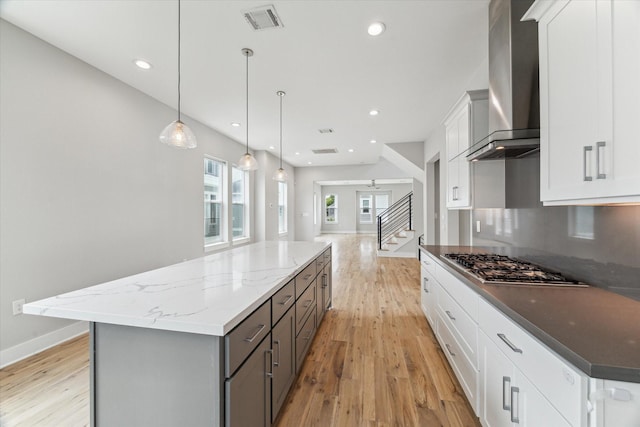 919 W 16th St Unit C, Houston, TX 77008 - kitchen featuring wall chimney exhaust hood, stainless steel gas stovetop, a kitchen island, light wood finished floors, and recessed lighting