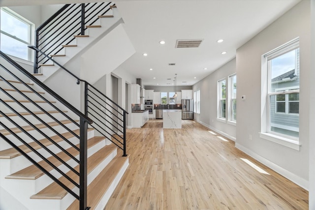 919 W 16th St Unit C, Houston, TX 77008 - stairs featuring hardwood / wood-style floors and recessed lighting