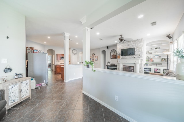 18403 Sierra Falls Ct, Tomball, TX 77377 - kitchen featuring ceiling fan, open floor plan, arched walkways, a stone fireplace, and recessed lighting
