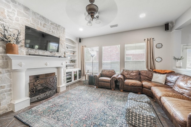 18403 Sierra Falls Ct, Tomball, TX 77377 - living room featuring built in features, a fireplace, and tile patterned floors