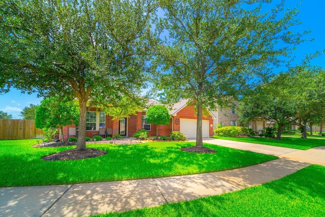 18403 Sierra Falls Ct, Tomball, TX 77377 - view of property hidden behind natural elements with driveway, brick siding, and a garage