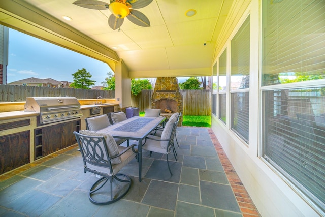 18403 Sierra Falls Ct, Tomball, TX 77377 - fenced backyard featuring outdoor dining space, exterior kitchen, a patio, and ceiling fan