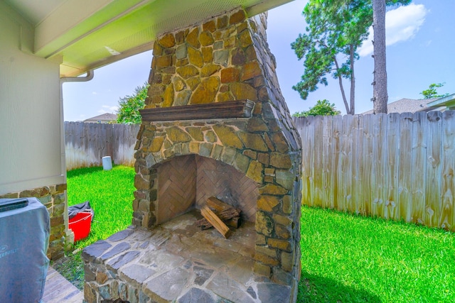 18403 Sierra Falls Ct, Tomball, TX 77377 - fenced backyard with an outdoor stone fireplace