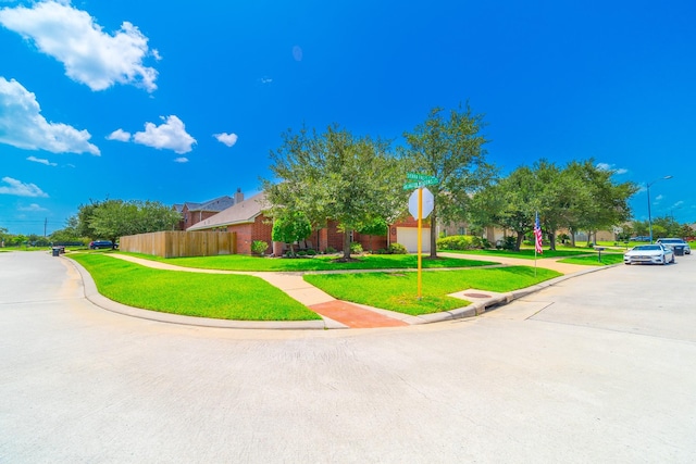 18403 Sierra Falls Ct, Tomball, TX 77377 - view of property hidden behind natural elements with brick siding