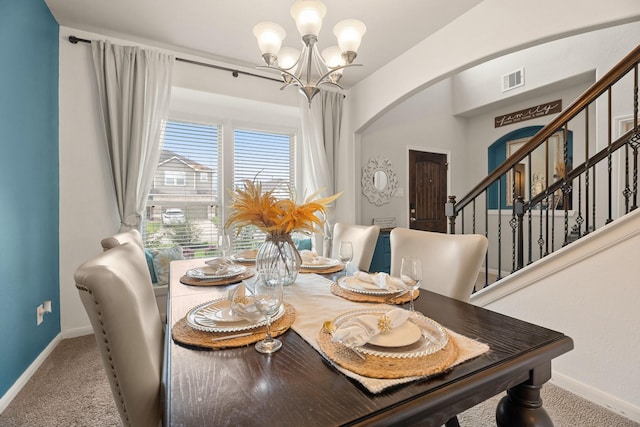 4738 Alluvial Cir, Alvin, TX 77511 - carpeted dining room with arched walkways, a chandelier, and stairway