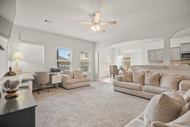 4738 Alluvial Cir, Alvin, TX 77511 - living room with ceiling fan, light carpet, a desk, and arched walkways