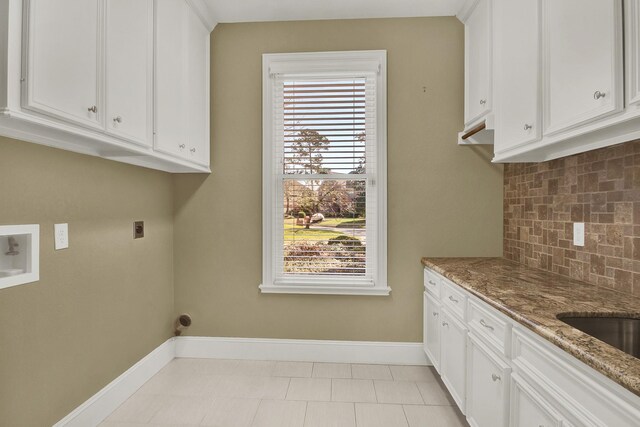 13714 Gainesway Dr, Cypress, TX 77429 - washroom featuring hookup for an electric dryer, cabinet space, and hookup for a washing machine