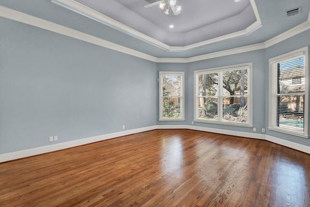 13714 Gainesway Dr, Cypress, TX 77429 - empty room featuring wood finished floors, a raised ceiling, and ornamental molding