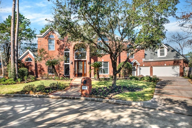 13714 Gainesway Dr, Cypress, TX 77429 - traditional-style home with brick siding, concrete driveway, a front lawn, and an attached garage