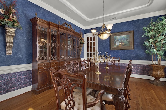 13714 Gainesway Dr, Cypress, TX 77429 - dining space featuring wallpapered walls, wood finished floors, a raised ceiling, a chandelier, and ornamental molding
