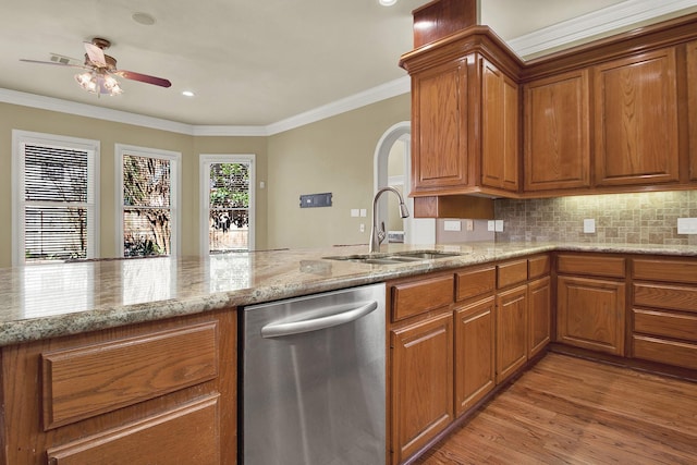 13714 Gainesway Dr, Cypress, TX 77429 - kitchen with stainless steel dishwasher, brown cabinetry, a ceiling fan, light stone counters, and crown molding