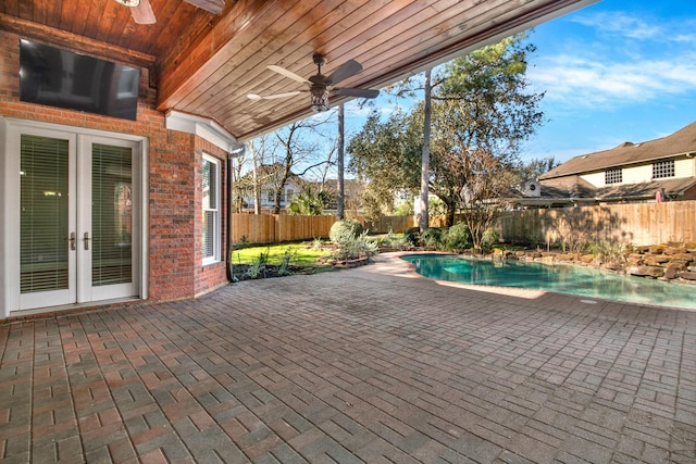 13714 Gainesway Dr, Cypress, TX 77429 - fenced backyard featuring a ceiling fan, french doors, and a patio area