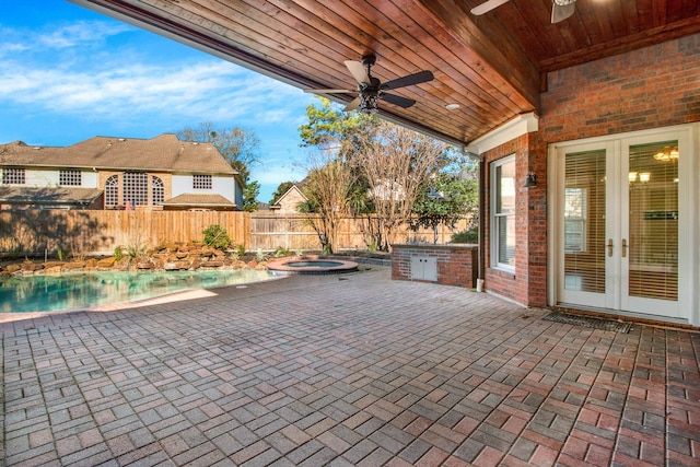 13714 Gainesway Dr, Cypress, TX 77429 - fenced backyard featuring french doors, a ceiling fan, a patio area, and a pool with connected hot tub