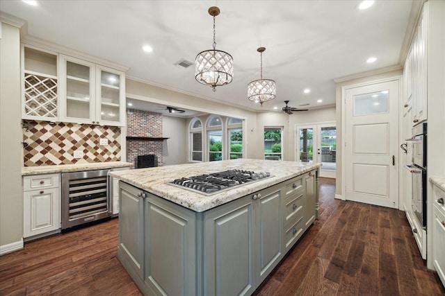 13307 Oddom Ct, Cypress, TX 77429 - kitchen featuring beverage cooler, stainless steel gas cooktop, gray cabinetry, a ceiling fan, and decorative backsplash