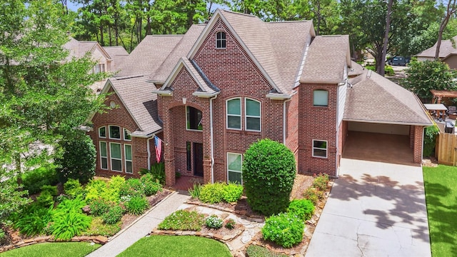 13307 Oddom Ct, Cypress, TX 77429 - view of front facade with brick siding, driveway, a shingled roof, and a carport