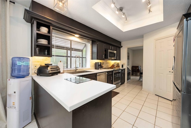 3618 Coltwood Dr, Spring, TX 77388 - kitchen featuring backsplash, a peninsula, light countertops, a raised ceiling, and crown molding