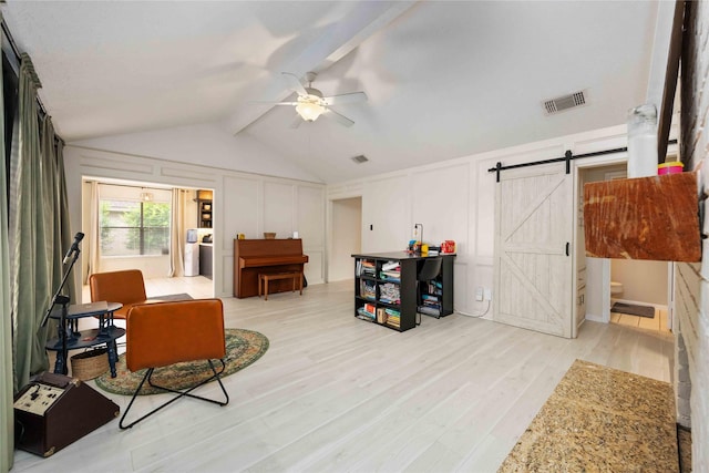 3618 Coltwood Dr, Spring, TX 77388 - living area with a decorative wall, a ceiling fan, lofted ceiling, light wood-style floors, and a barn door
