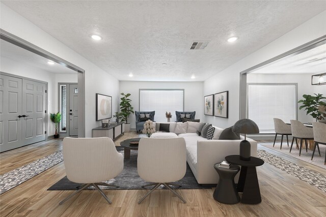 10011 Cliffwood Dr, Houston, TX 77035 - living area with a textured ceiling, light wood-style floors, and recessed lighting