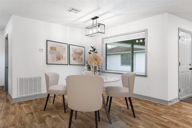 10011 Cliffwood Dr, Houston, TX 77035 - dining space featuring light wood-type flooring and a textured ceiling