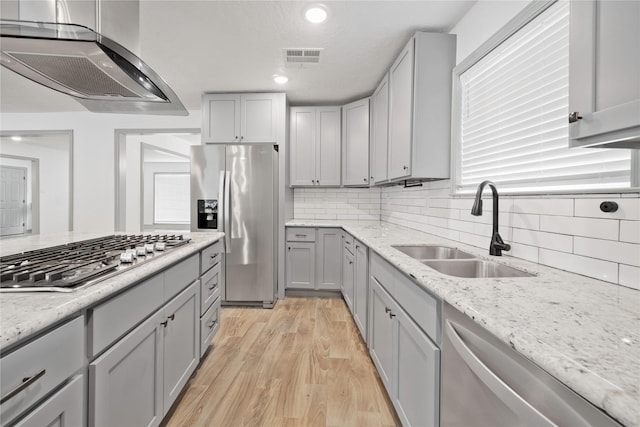 10011 Cliffwood Dr, Houston, TX 77035 - kitchen with stainless steel appliances, wall chimney exhaust hood, gray cabinets, backsplash, and recessed lighting