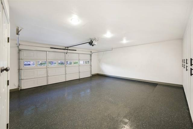 10011 Cliffwood Dr, Houston, TX 77035 - garage featuring a garage door opener and baseboards