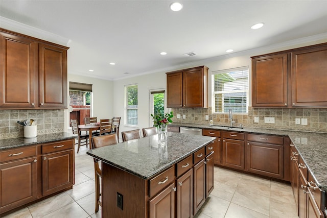 12106 Coldwater Cove Ln, Cypress, TX 77433 - kitchen with tasteful backsplash, stainless steel dishwasher, light tile patterned flooring, a center island, and dark stone counters