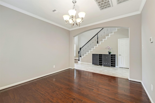 12106 Coldwater Cove Ln, Cypress, TX 77433 - unfurnished living room with arched walkways, a chandelier, wood finished floors, stairway, and crown molding