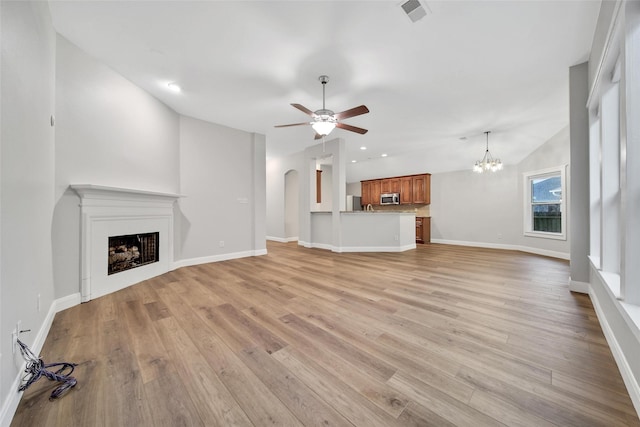28006 Brendon Trail Ct, Spring, TX 77386 - unfurnished living room featuring a fireplace, ceiling fan, light wood-style flooring, a chandelier, and recessed lighting