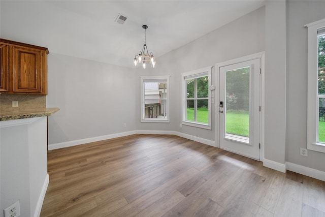 28006 Brendon Trail Ct, Spring, TX 77386 - unfurnished dining area with light wood finished floors and a chandelier