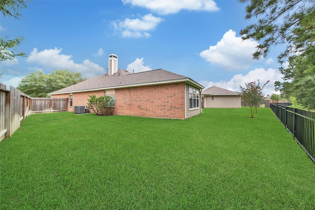 28006 Brendon Trail Ct, Spring, TX 77386 - rear view of house featuring brick siding, a fenced backyard, a chimney, and roof with shingles