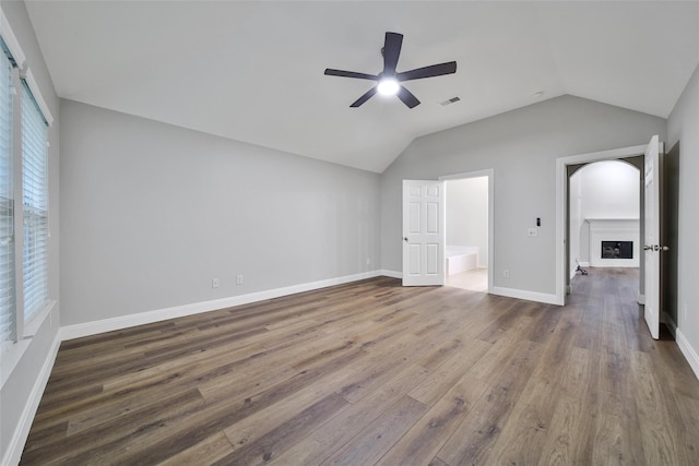 28006 Brendon Trail Ct, Spring, TX 77386 - unfurnished bedroom with wood finished floors, lofted ceiling, and a ceiling fan