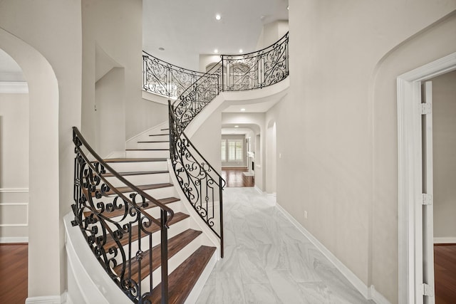 22419 Rippling Shore Ct, Katy, TX 77494 - stairs with arched walkways, a high ceiling, recessed lighting, and marble finish flooring