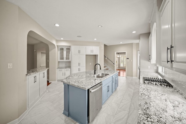 22419 Rippling Shore Ct, Katy, TX 77494 - kitchen featuring stainless steel appliances, white cabinetry, recessed lighting, a center island with sink, and light stone countertops