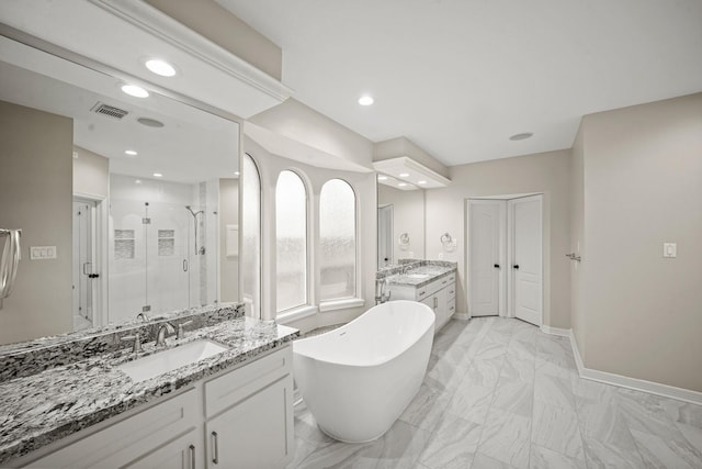 22419 Rippling Shore Ct, Katy, TX 77494 - bathroom featuring a shower stall, two vanities, a soaking tub, marble finish floors, and recessed lighting