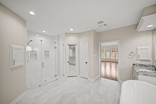 22419 Rippling Shore Ct, Katy, TX 77494 - bathroom with a shower stall, a soaking tub, vanity, marble look tile flooring, and recessed lighting