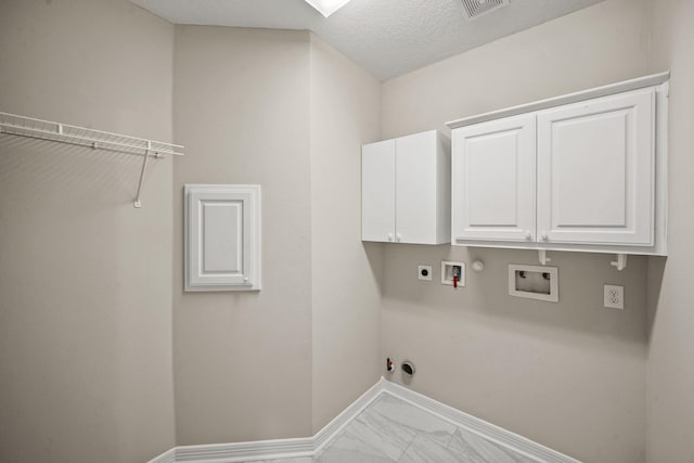 22419 Rippling Shore Ct, Katy, TX 77494 - laundry room featuring gas dryer hookup, hookup for an electric dryer, hookup for a washing machine, marble look tile flooring, and cabinet space