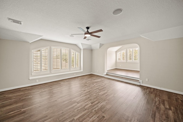 22419 Rippling Shore Ct, Katy, TX 77494 - additional living space with a ceiling fan, a textured ceiling, wood finished floors, vaulted ceiling, and arched walkways