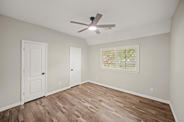 22419 Rippling Shore Ct, Katy, TX 77494 - unfurnished bedroom with wood finished floors, a ceiling fan, and vaulted ceiling