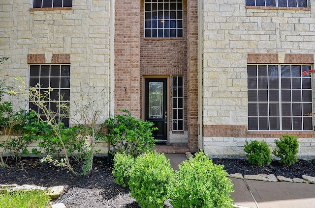 24914 Hazel Ranch Dr, Katy, TX 77494 - doorway to property featuring stone siding and brick siding