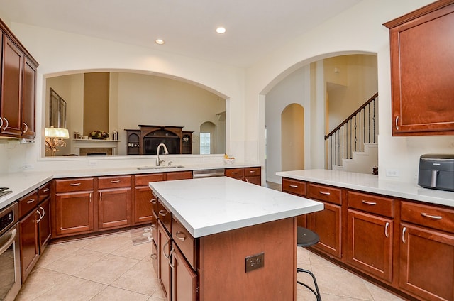 24914 Hazel Ranch Dr, Katy, TX 77494 - kitchen featuring light tile patterned floors, a kitchen island, recessed lighting, stainless steel appliances, and a peninsula