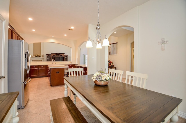 24914 Hazel Ranch Dr, Katy, TX 77494 - dining room featuring arched walkways, recessed lighting, light tile patterned flooring, and a chandelier