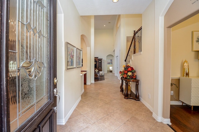 24914 Hazel Ranch Dr, Katy, TX 77494 - foyer entrance with arched walkways, stairs, light tile patterned floors, and recessed lighting