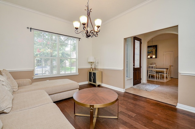 24914 Hazel Ranch Dr, Katy, TX 77494 - living area with dark wood finished floors, ornamental molding, arched walkways, and a chandelier