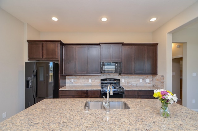 3238 Montclair Orchard Trce, Spring, TX 77386 - kitchen featuring black appliances, dark brown cabinetry, tasteful backsplash, and recessed lighting
