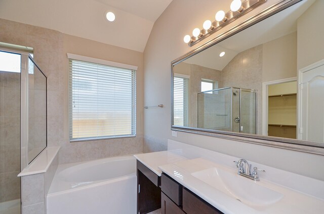 3238 Montclair Orchard Trce, Spring, TX 77386 - bathroom featuring vaulted ceiling, vanity, a garden tub, a stall shower, and a walk in closet