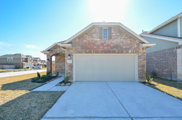 3238 Montclair Orchard Trce, Spring, TX 77386 - view of front of home featuring brick siding, driveway, an attached garage, and a front lawn