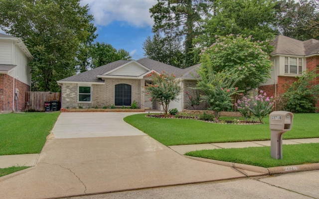 22718 Red Pine Dr, Tomball, TX 77375 - view of front of house featuring driveway, brick siding, and roof with shingles