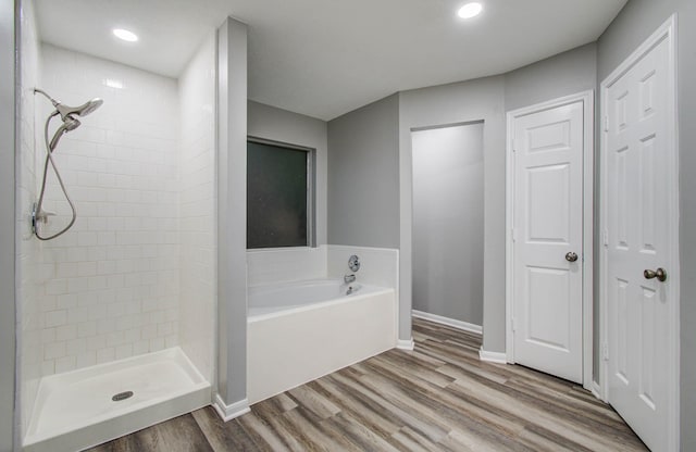 22718 Red Pine Dr, Tomball, TX 77375 - full bathroom featuring a garden tub, wood finished floors, a tile shower, and recessed lighting