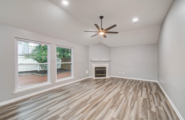 22718 Red Pine Dr, Tomball, TX 77375 - unfurnished living room with light wood-type flooring, ceiling fan, lofted ceiling, a fireplace, and recessed lighting